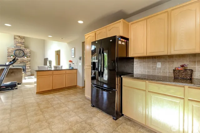 a kitchen with stainless steel appliances granite countertop a refrigerator and a sink