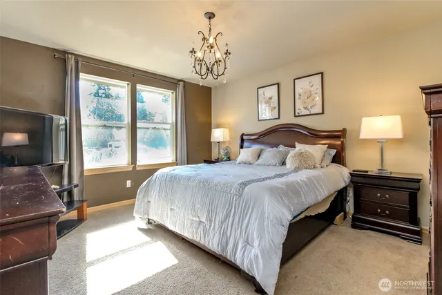 a bedroom with a large bed and a window