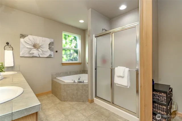 a bathroom with a tub shower and sink