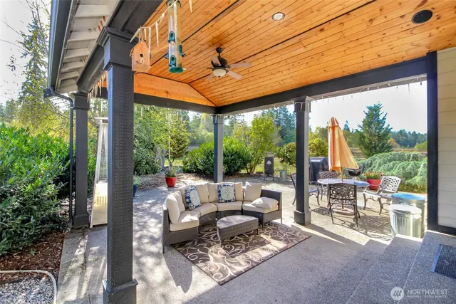 a living room with patio furniture and garden view