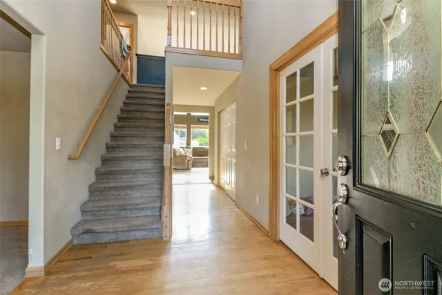 a view of an entryway with wooden floor