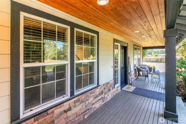 a house view with a seating space and wooden floor
