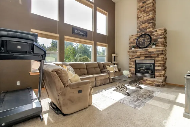 a living room with furniture a fireplace and a window
