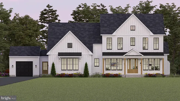 a front view of a house with a garden and yard