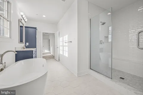 a large bathroom with a tub and shower