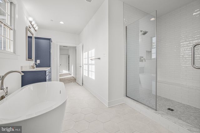 a large bathroom with a tub and shower