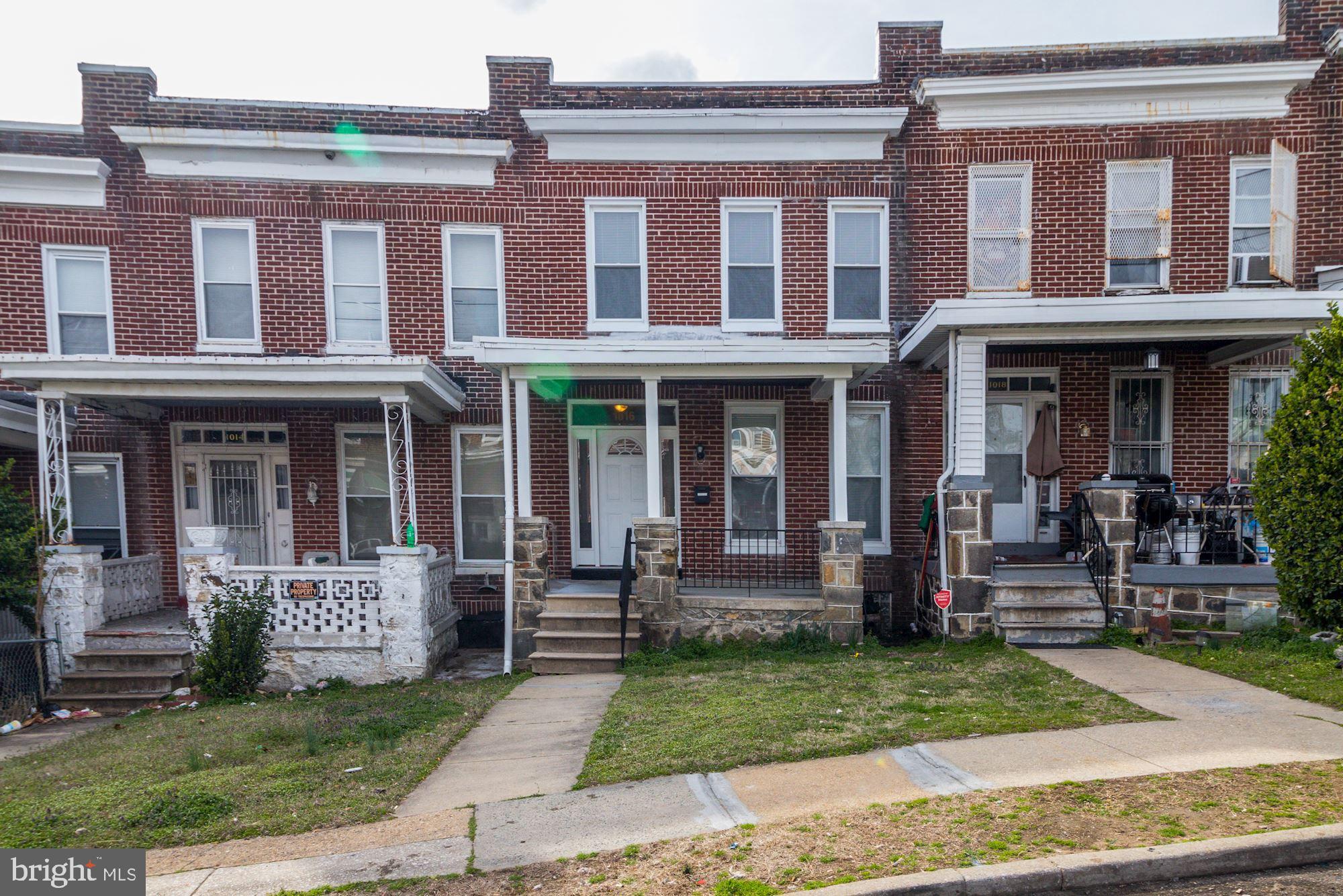 1016 North Rosedale Street Baltimore, MD 21216 - Photo 1 of 58 a front view of a house with a yard