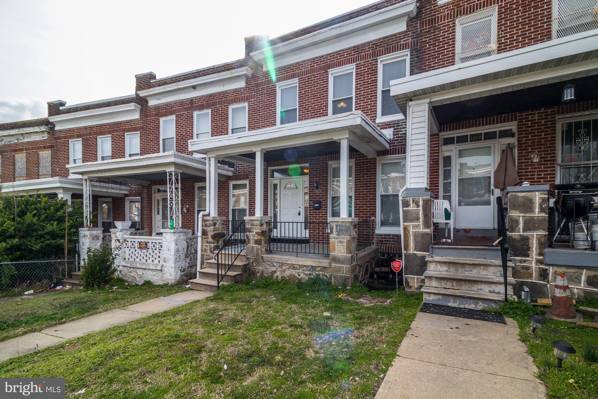 1016 North Rosedale Street Baltimore, MD 21216 - Photo 2 of 58 a front view of a house with garden