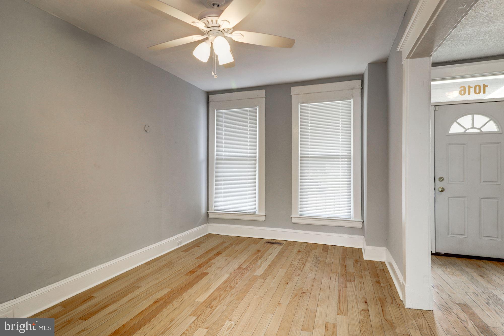 1016 North Rosedale Street Baltimore, MD 21216 - Photo 11 of 58 an empty room with wooden floor closet and windows