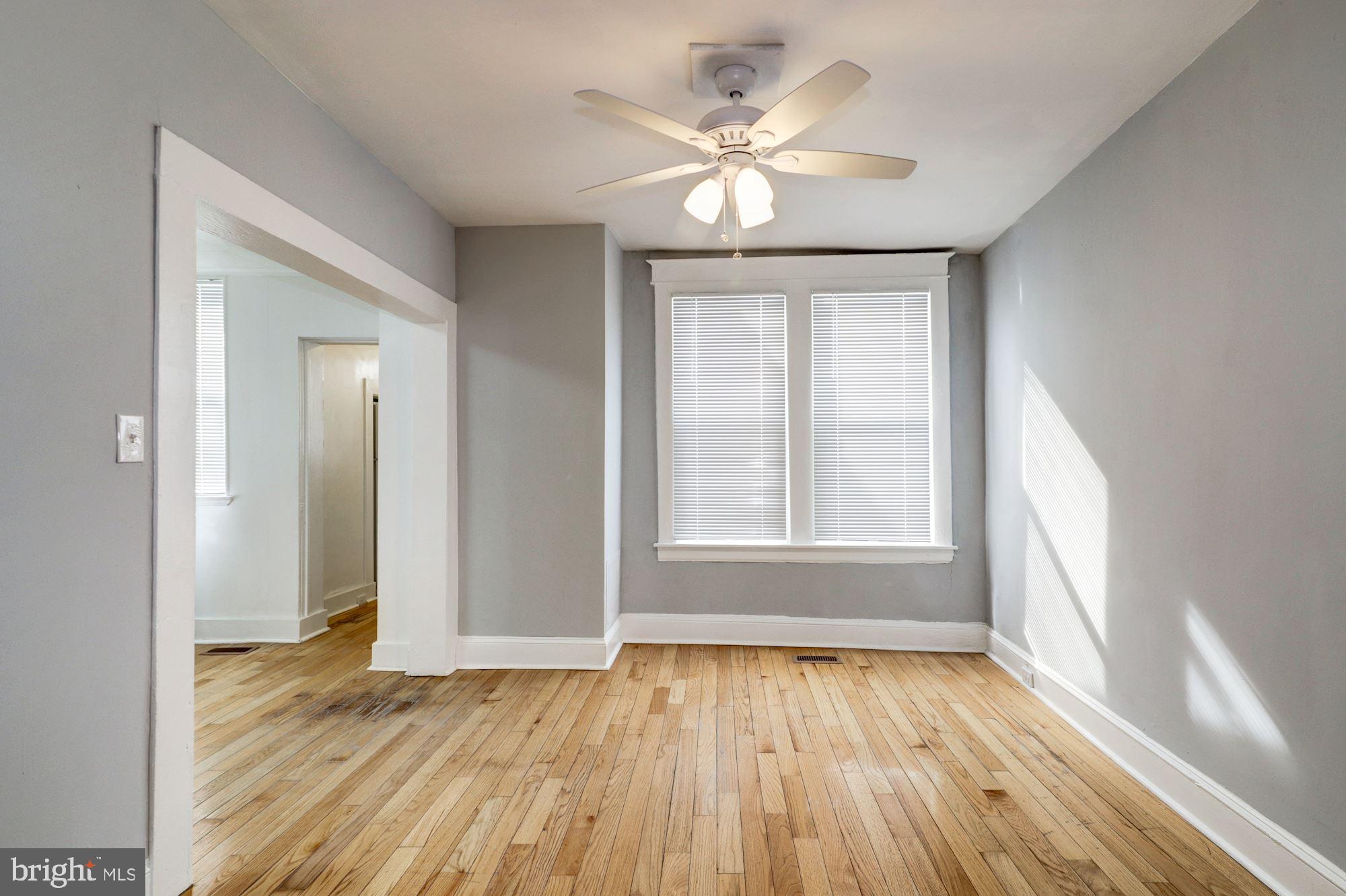 1016 North Rosedale Street Baltimore, MD 21216 - Photo 13 of 58 wooden floor in an empty room with a window