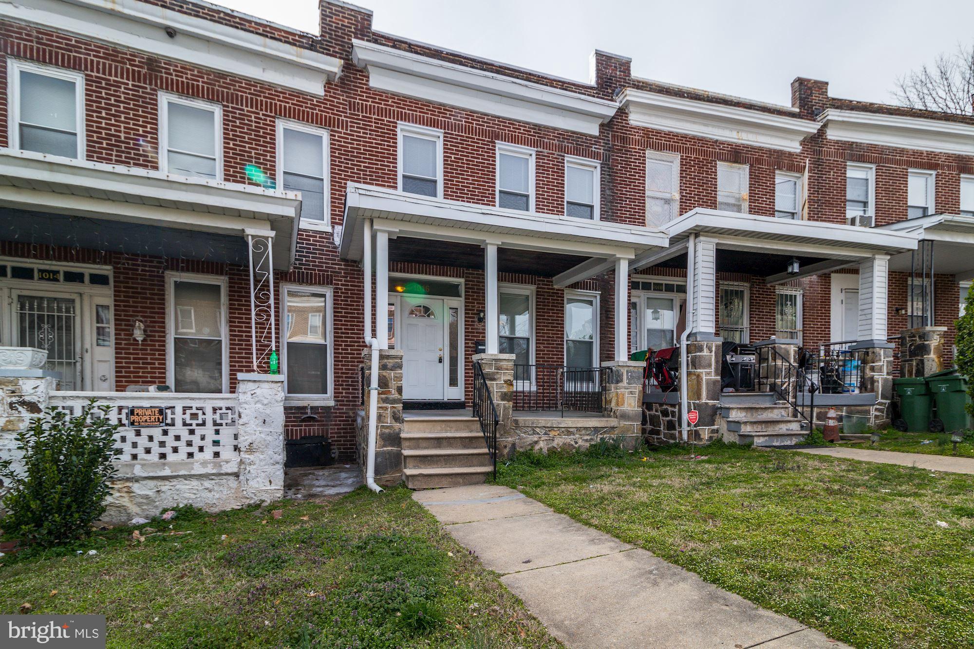 1016 North Rosedale Street Baltimore, MD 21216 - Photo 3 of 58 a view of a building with a yard and bench