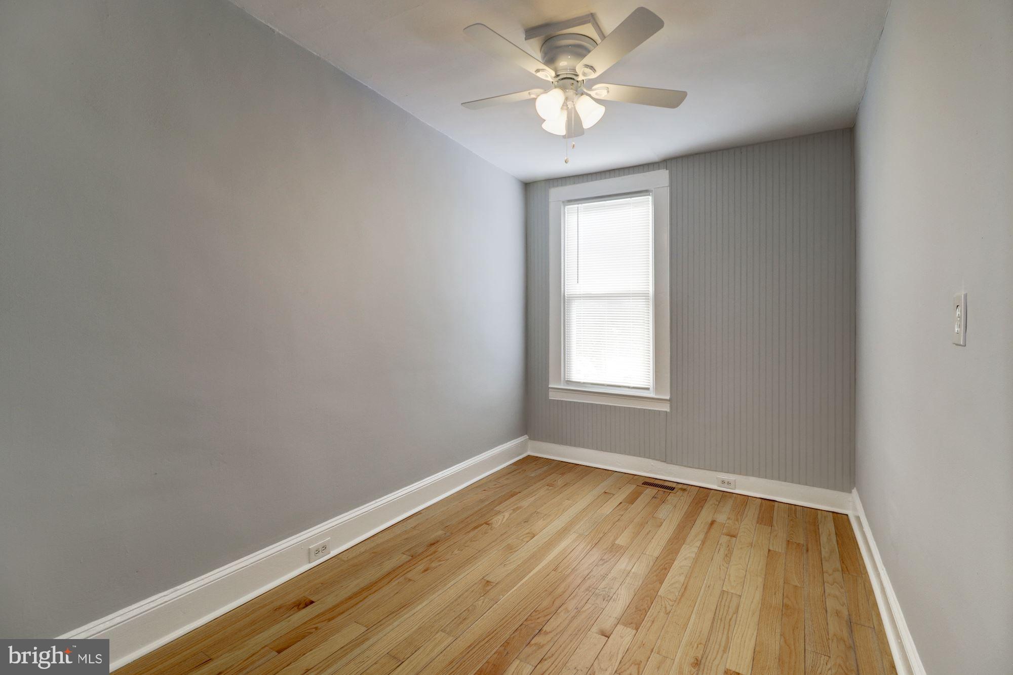 1016 North Rosedale Street Baltimore, MD 21216 - Photo 27 of 58 a view of empty room with wooden floor and fan
