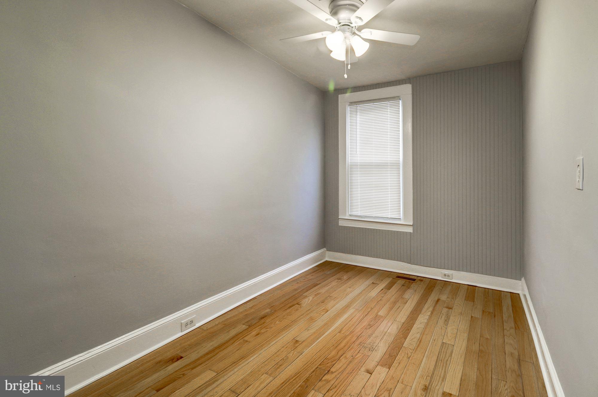 1016 North Rosedale Street Baltimore, MD 21216 - Photo 28 of 58 wooden floor in an empty room with a window