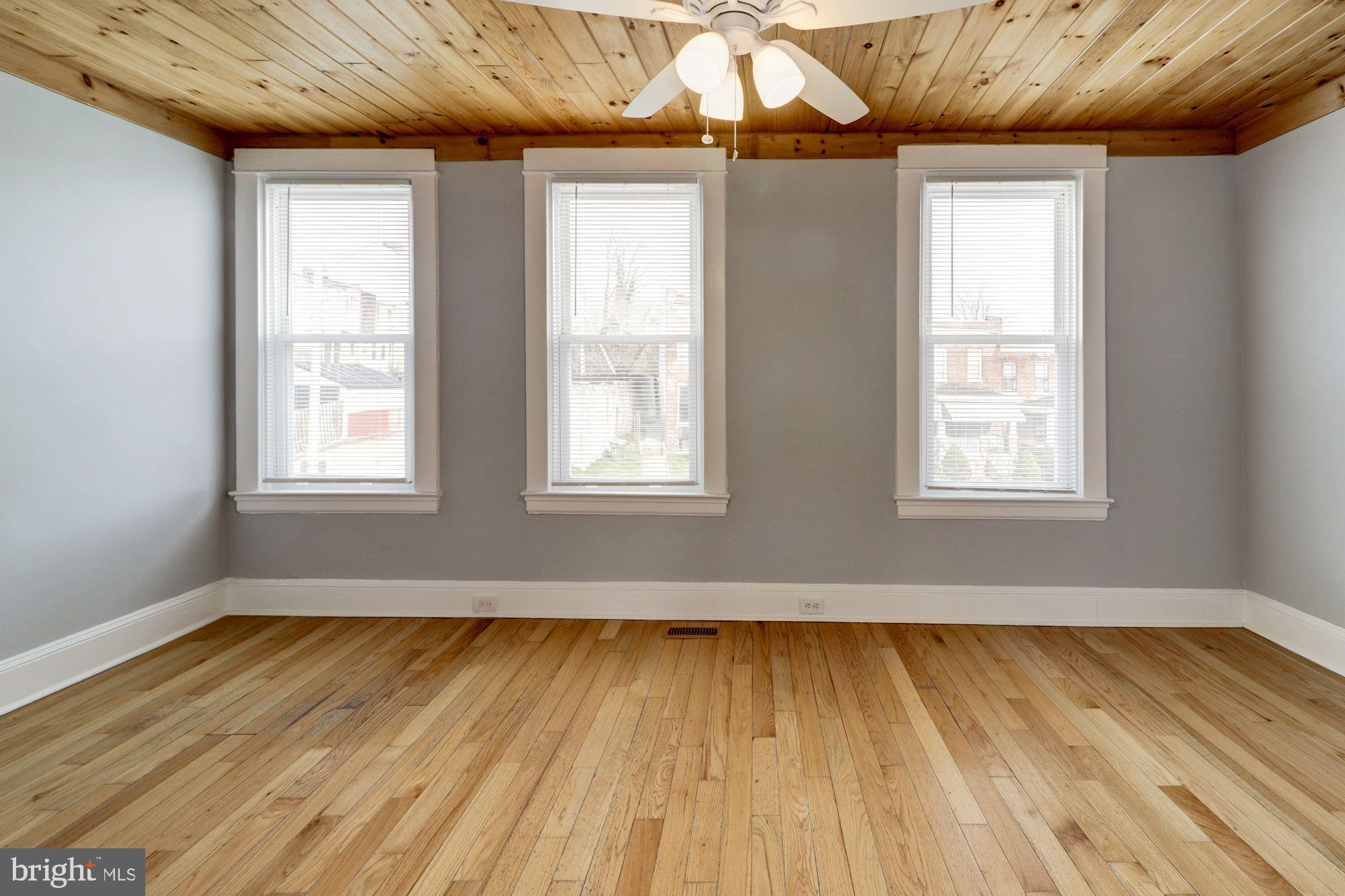 1016 North Rosedale Street Baltimore, MD 21216 - Photo 30 of 58 a view of an empty room with wooden floor and a window