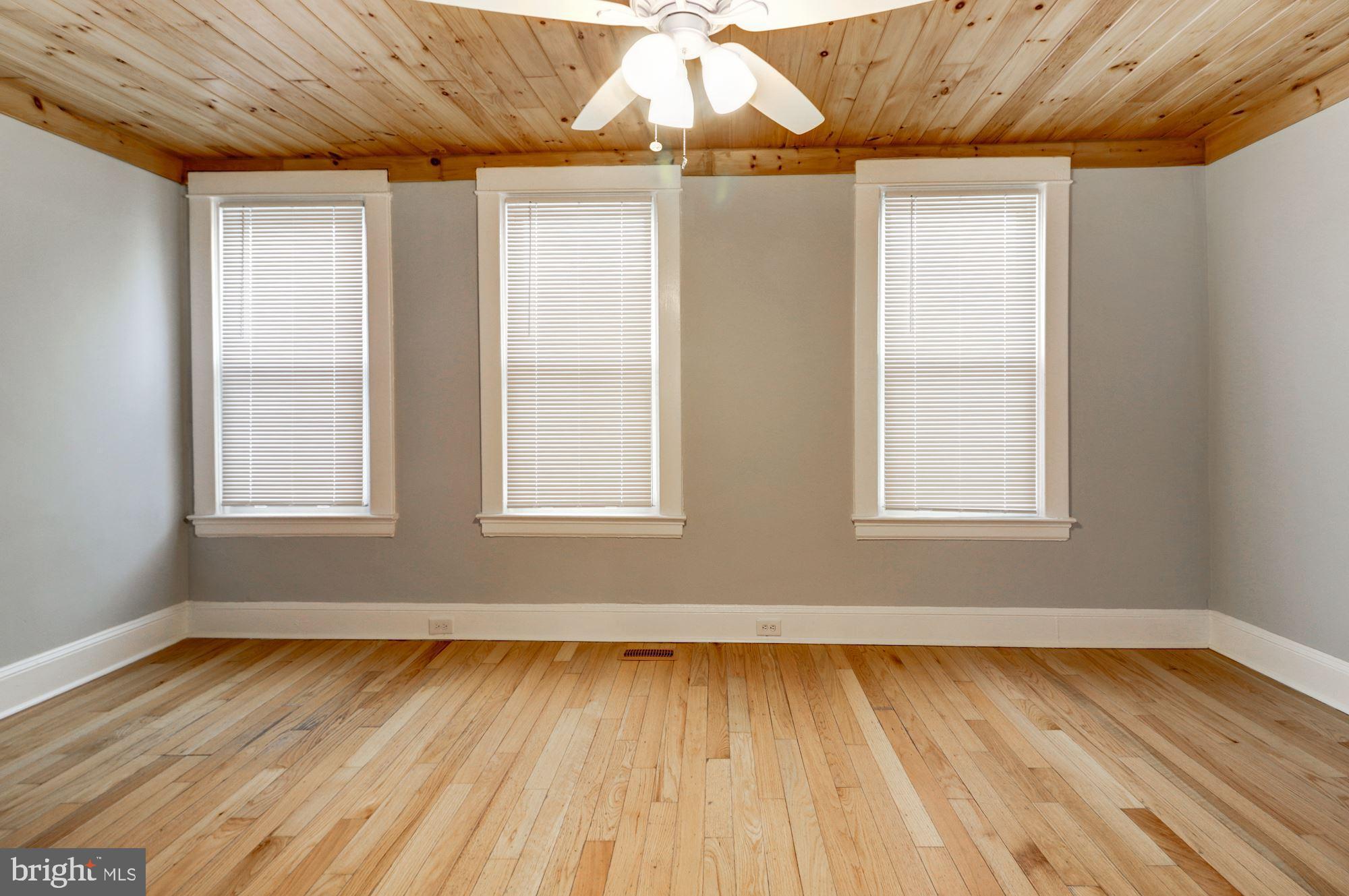 1016 North Rosedale Street Baltimore, MD 21216 - Photo 31 of 58 an empty room with wooden floor and windows