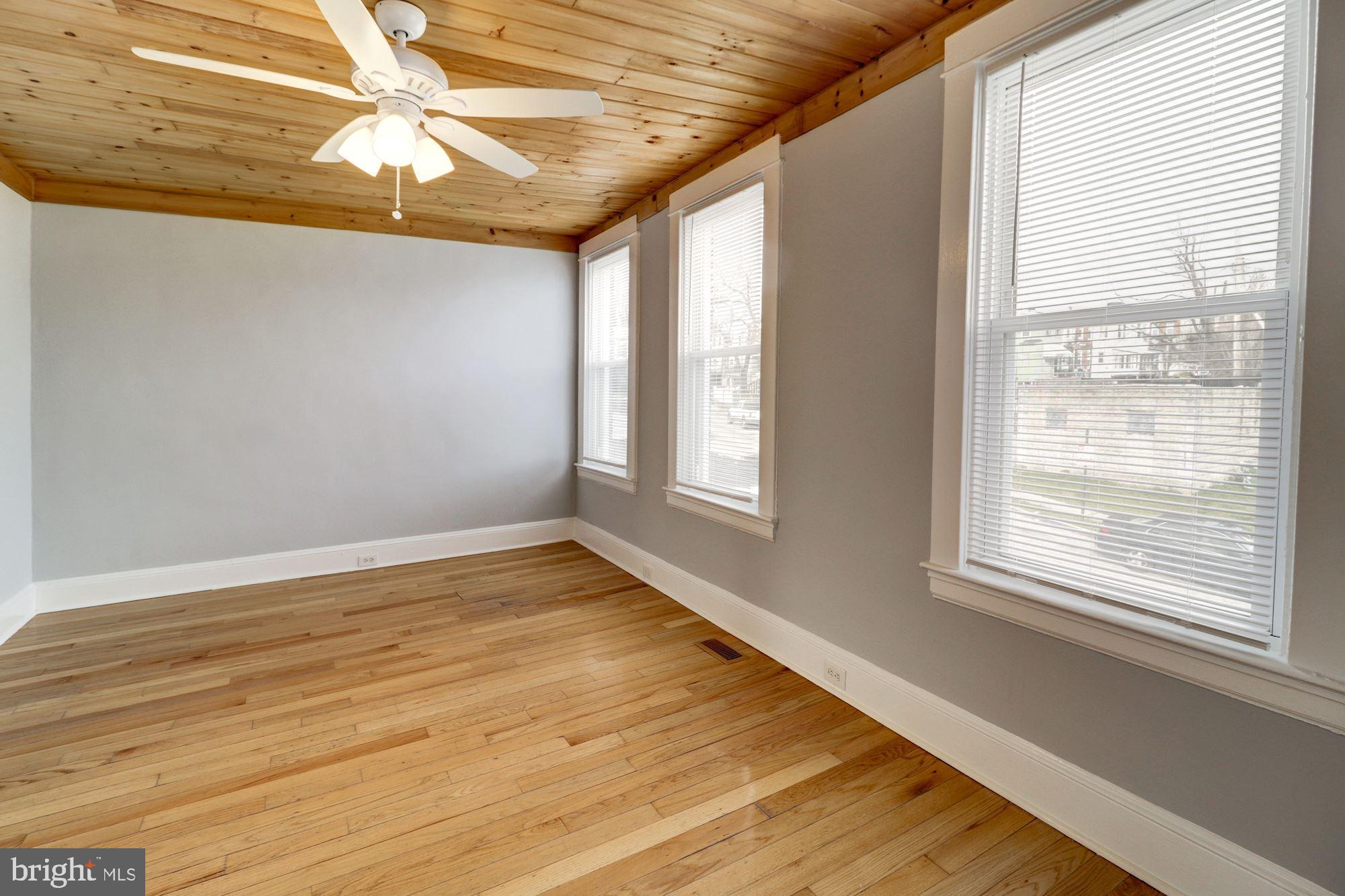 1016 North Rosedale Street Baltimore, MD 21216 - Photo 35 of 58 a view of an empty room with wooden floor and a window
