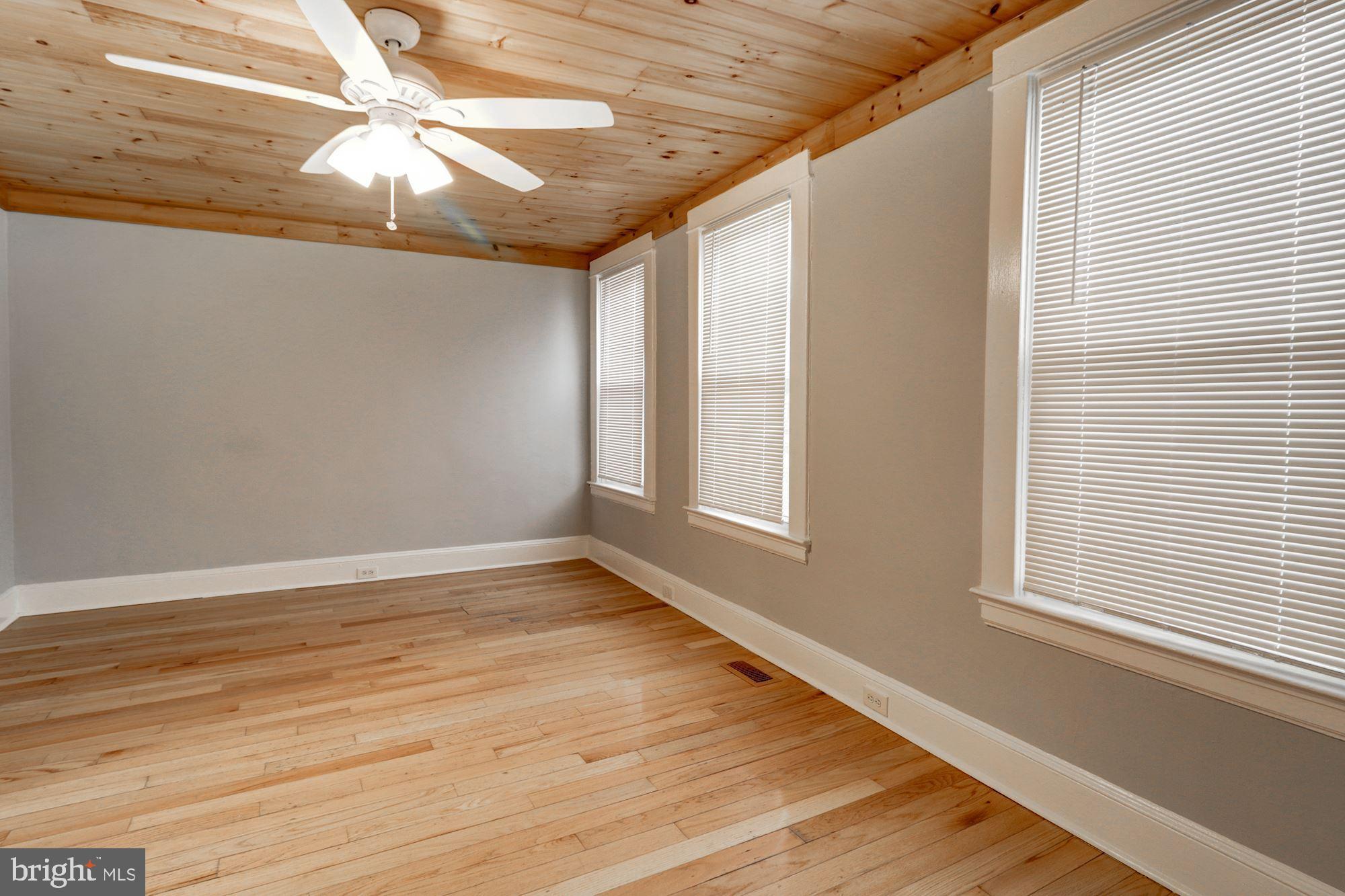 1016 North Rosedale Street Baltimore, MD 21216 - Photo 36 of 58 a view of an empty room with wooden floor and a window
