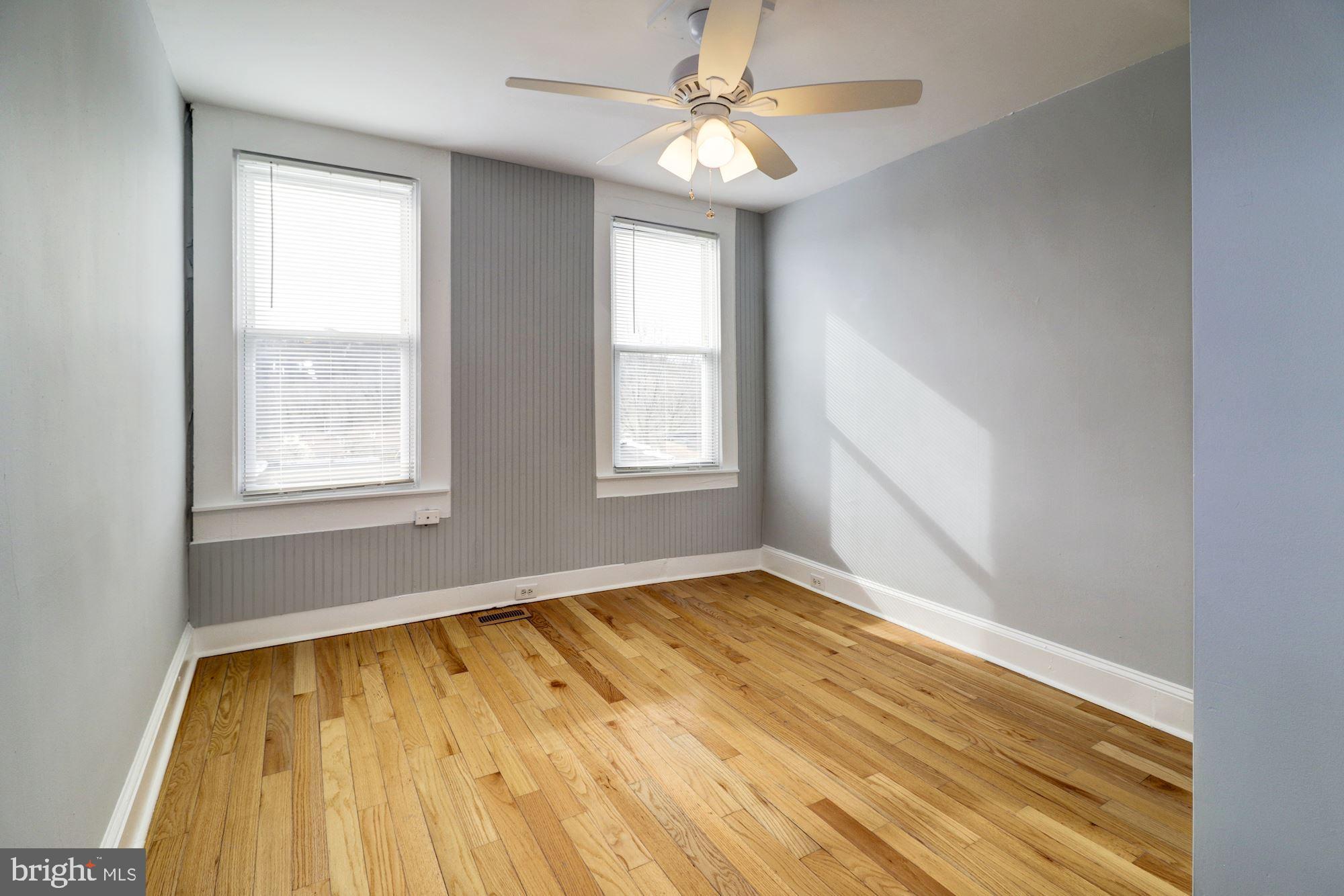1016 North Rosedale Street Baltimore, MD 21216 - Photo 39 of 58 a view of an empty room with wooden floor and a window