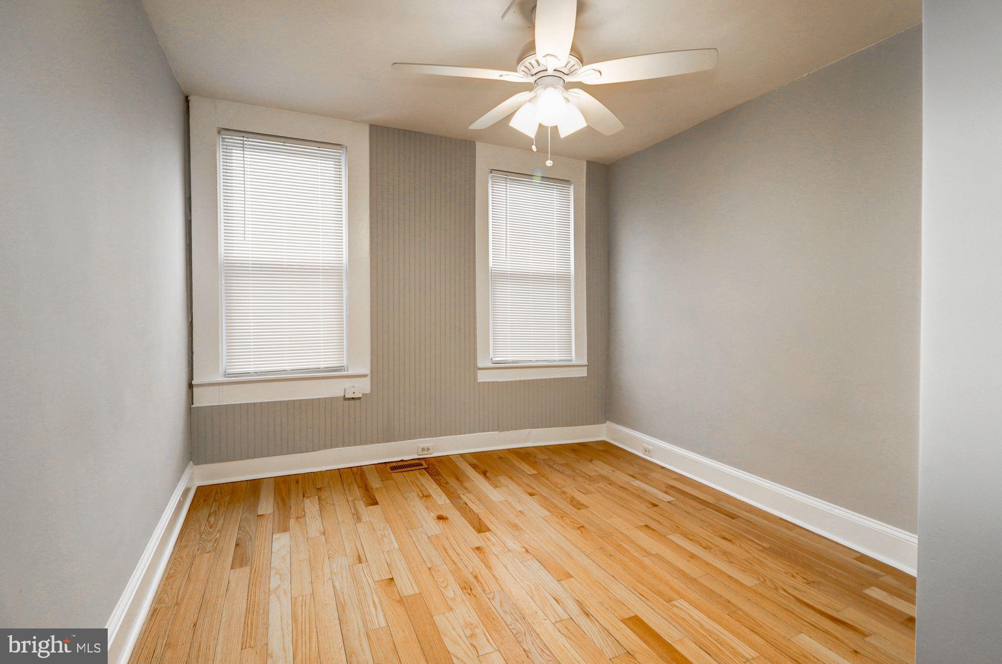 1016 North Rosedale Street Baltimore, MD 21216 - Photo 40 of 58 wooden floor in an empty room with a window