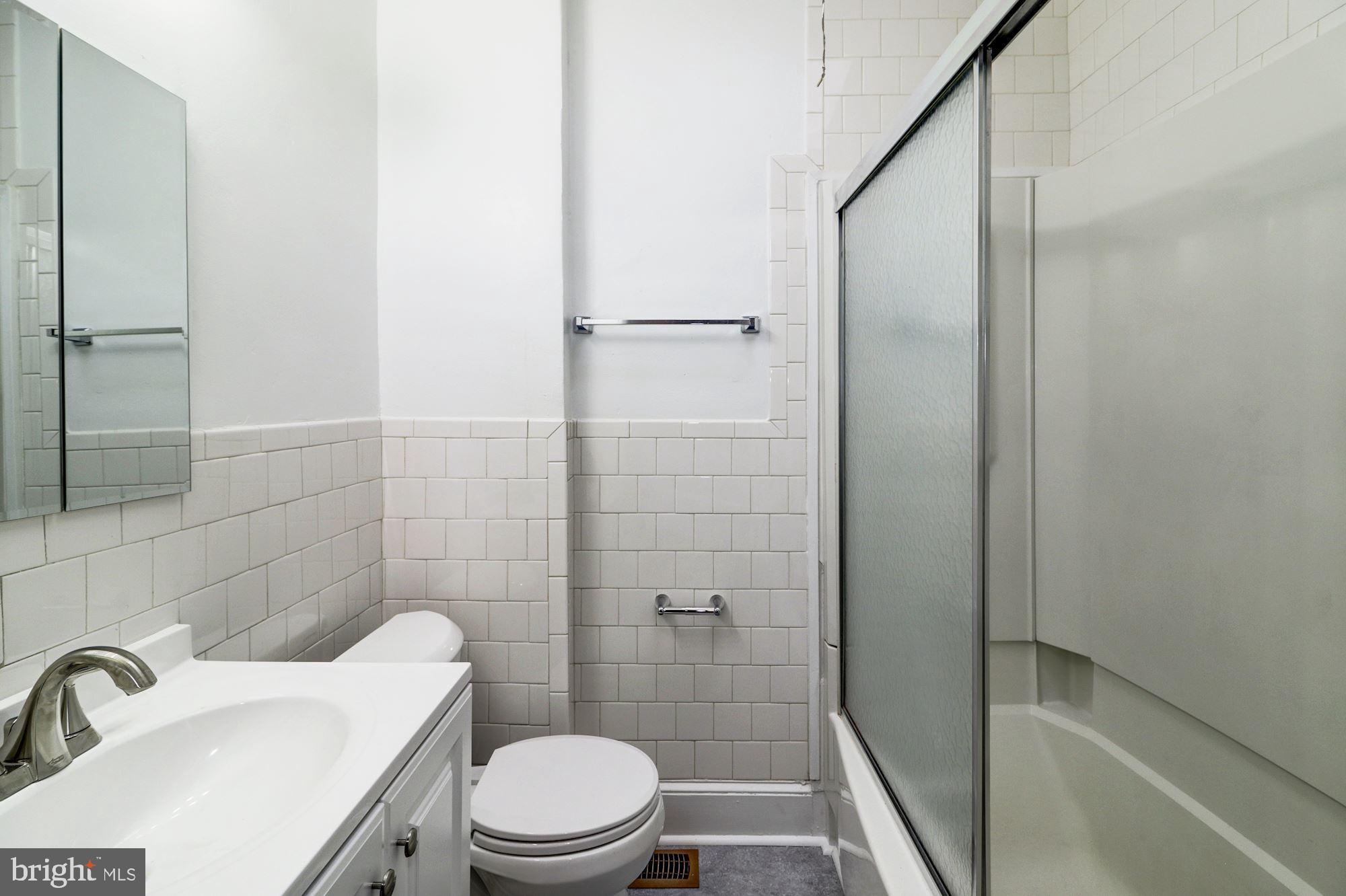 1016 North Rosedale Street Baltimore, MD 21216 - Photo 43 of 58 a bathroom with a sink a toilet and shower