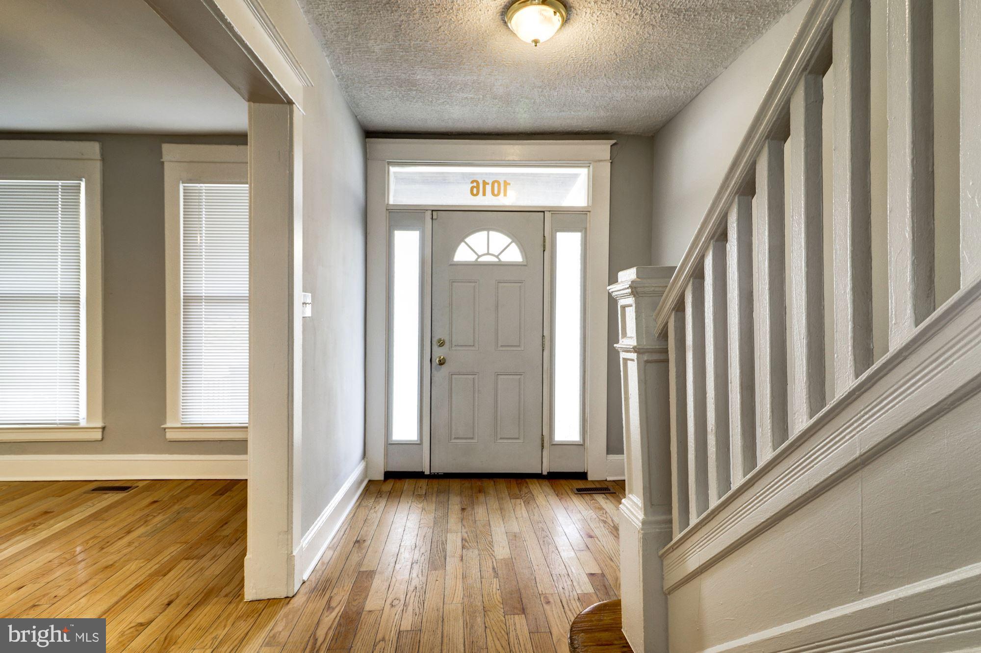 1016 North Rosedale Street Baltimore, MD 21216 - Photo 6 of 58 a view of a hallway with wooden floor and staircase