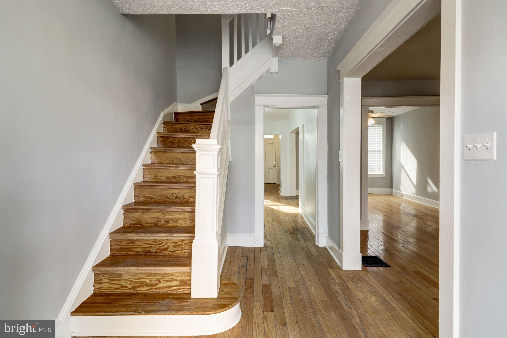 1016 North Rosedale Street Baltimore, MD 21216 - Photo 7 of 58 a view of a hallway with wooden floor and entryway
