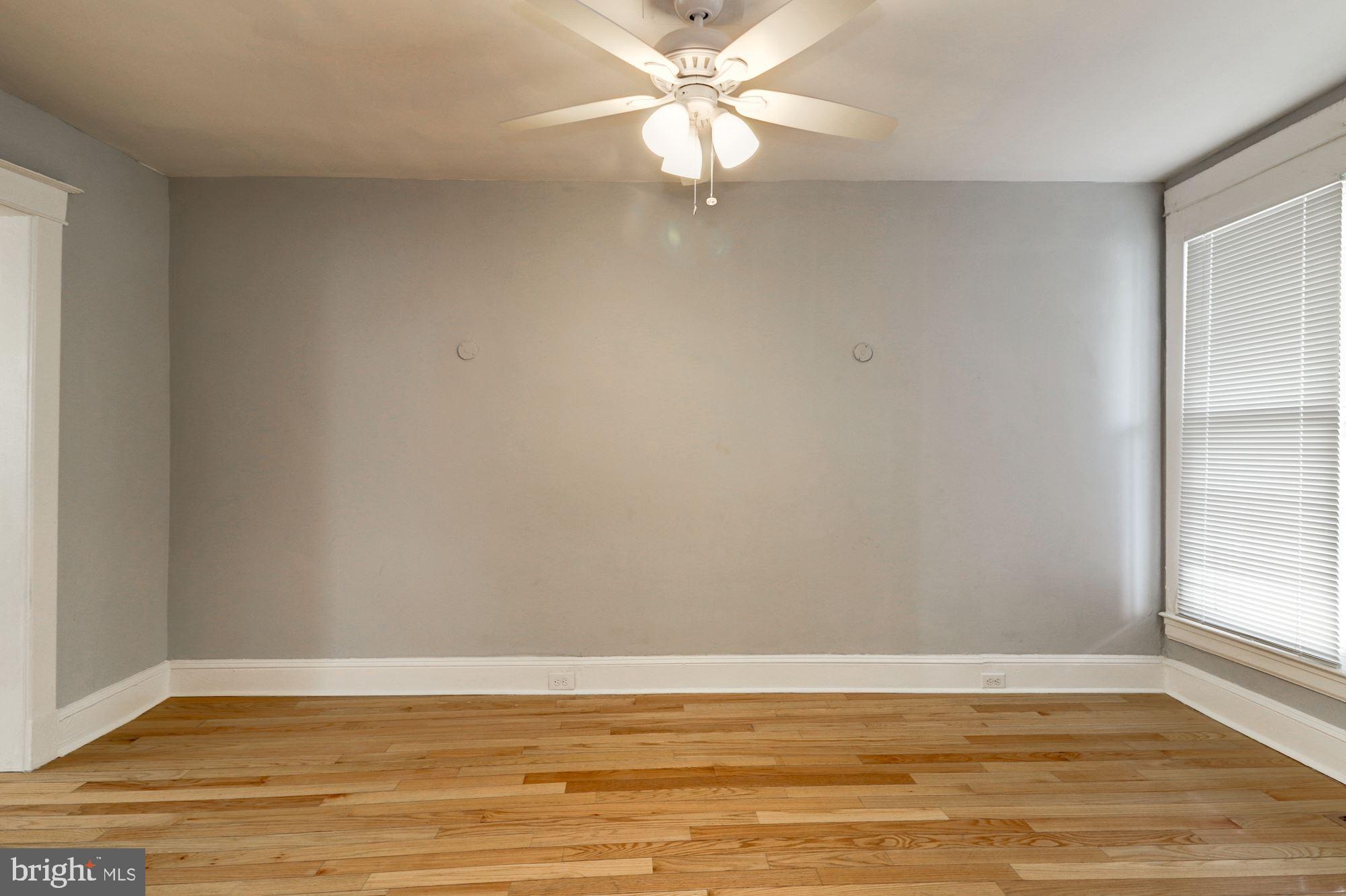 1016 North Rosedale Street Baltimore, MD 21216 - Photo 9 of 58 a view of an empty room with window and wooden floor