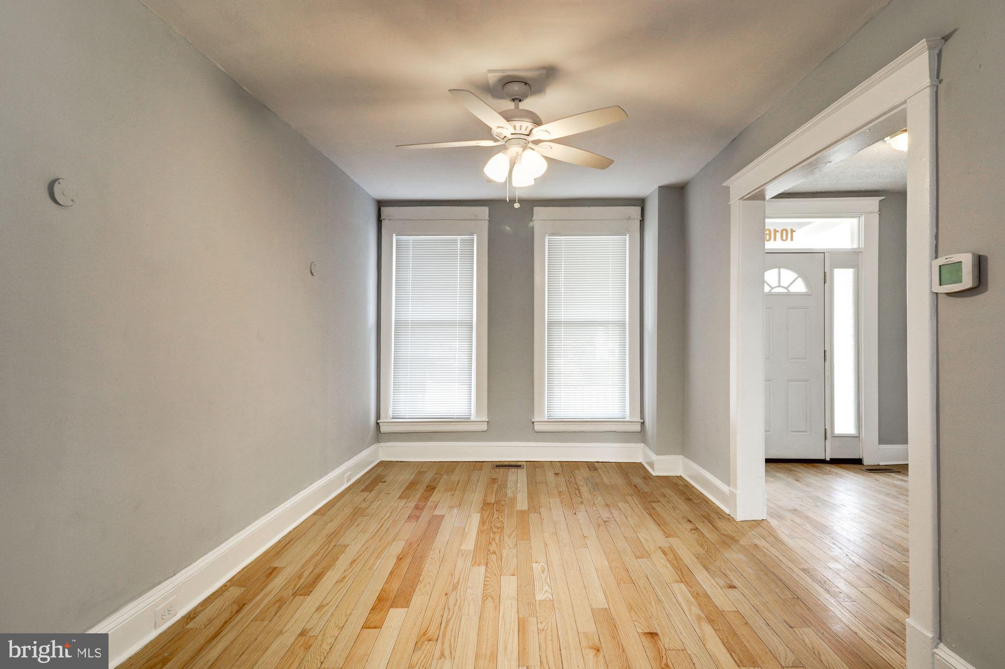 1016 North Rosedale Street Baltimore, MD 21216 - Photo 10 of 58 a view of an empty room with wooden floor and a window
