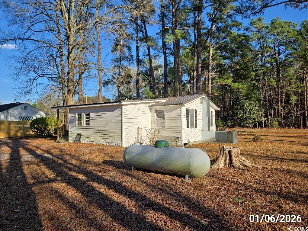 1341 Allison Landing Road Johnsonville, SC 29555 - Photo 15 of 27 View of property exterior with a central AC unit and a metal roof