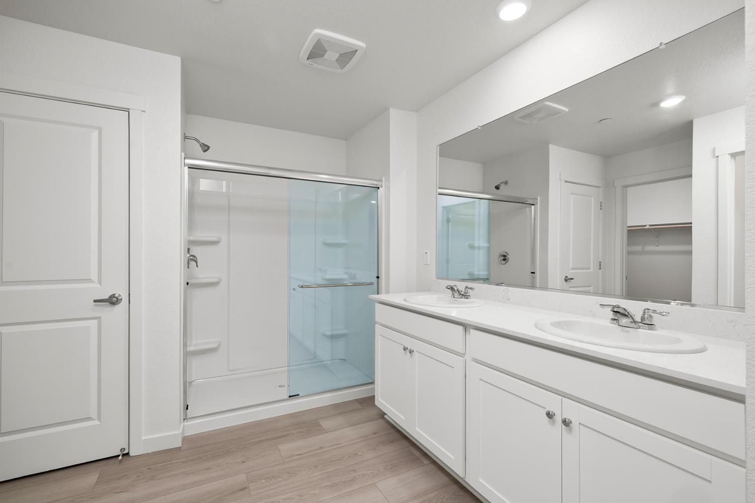 821 Helmsley Lane Patterson, CA 95363 - Photo 11 of 21 a bathroom with a shower sink and mirror