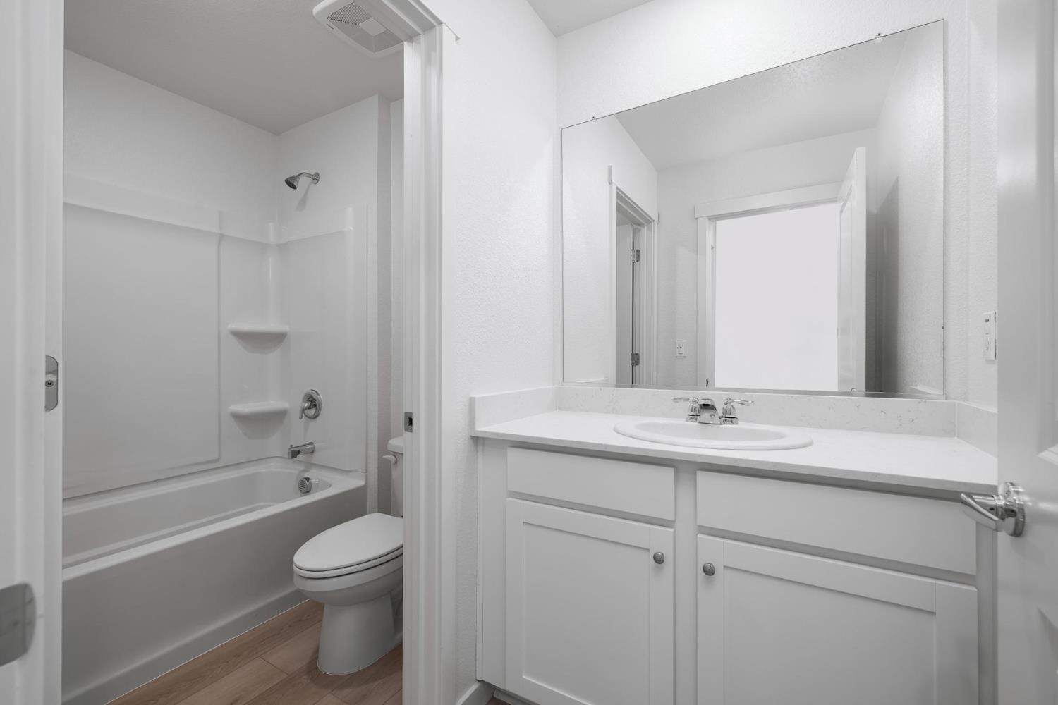 821 Helmsley Lane Patterson, CA 95363 - Photo 19 of 21 a bathroom with a toilet a sink a tub and mirror