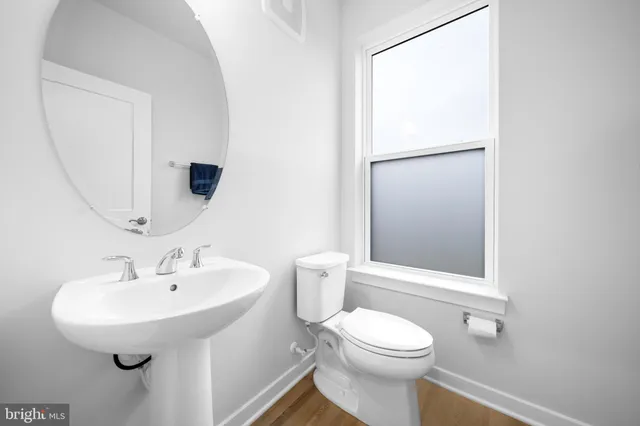 a view of a livingroom with furniture wooden floor and staircase