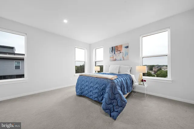 a spacious bedroom with a large bed and a window