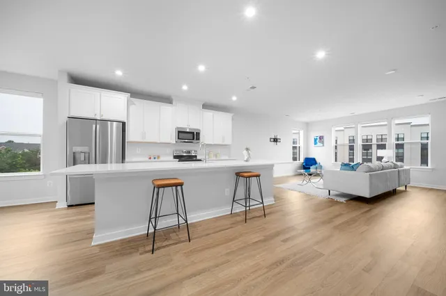 a kitchen with a sink cabinets and wooden floor