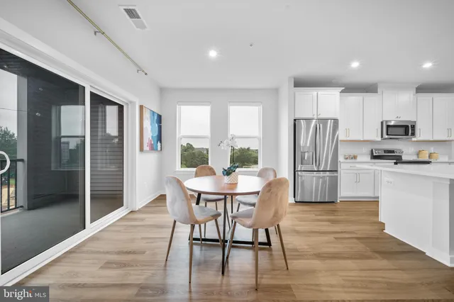 a view of a dining room with furniture and wooden floor