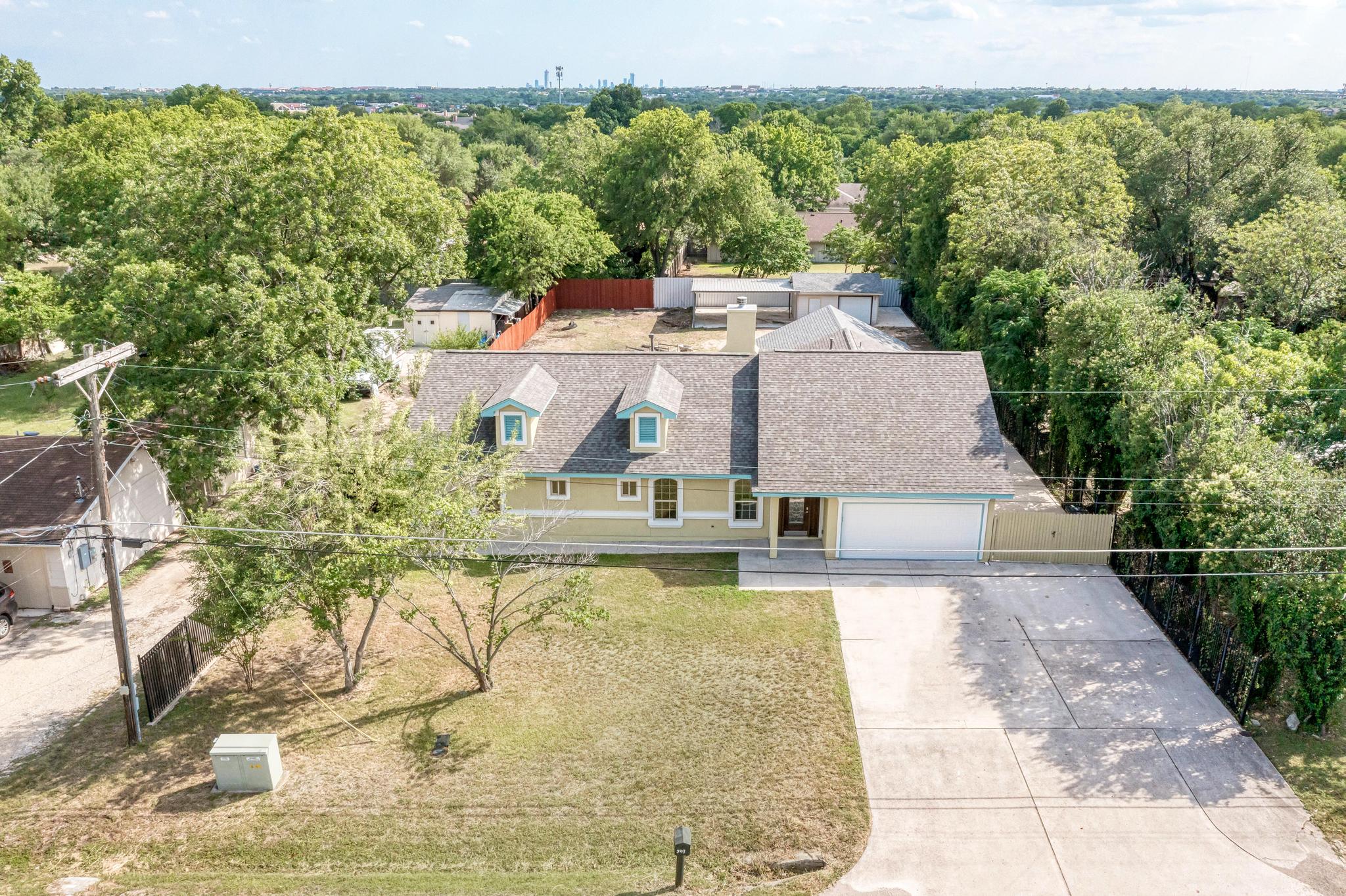 an aerial view of a house with a yard basket ball court and outdoor seating