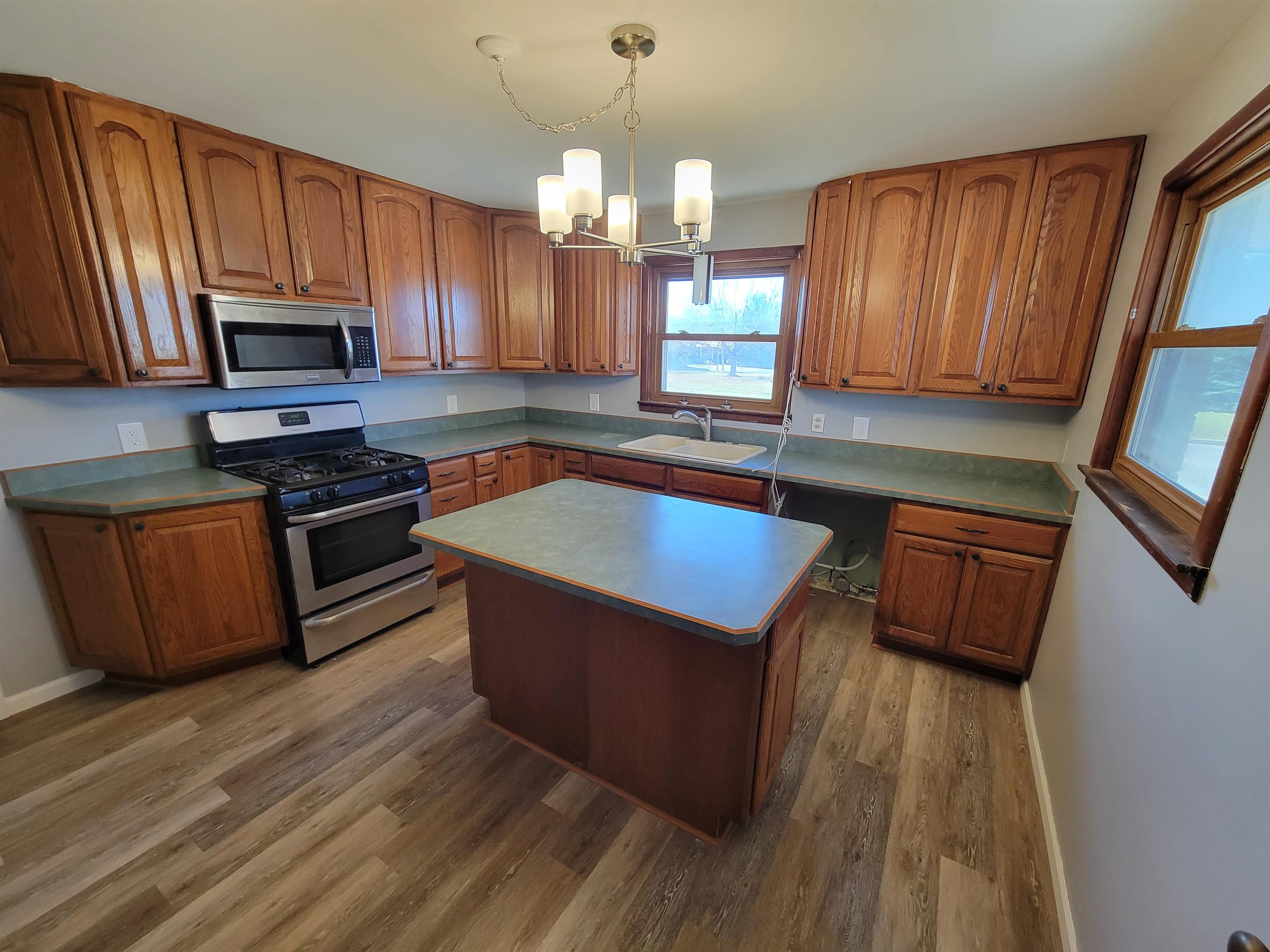 1352 Chartres Street LaSalle, IL 61301 - Photo 2 of 32 a kitchen with wooden floors a sink stainless steel appliances and cabinets