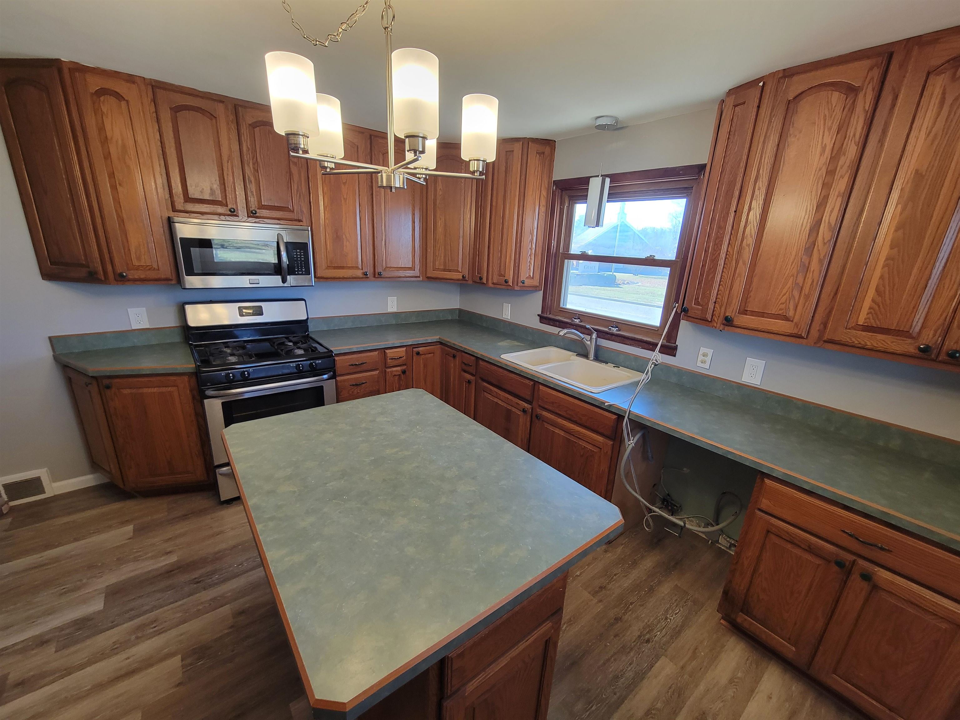 1352 Chartres Street LaSalle, IL 61301 - Photo 5 of 32 a kitchen with stainless steel appliances granite countertop wooden cabinets a stove a sink and dishwasher