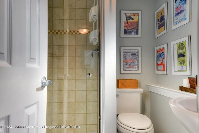 a white toilet sitting next to a bathroom sink