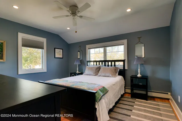 a large bedroom with a bed and a window