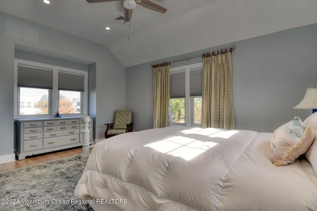 a bedroom with a bed dresser and a window