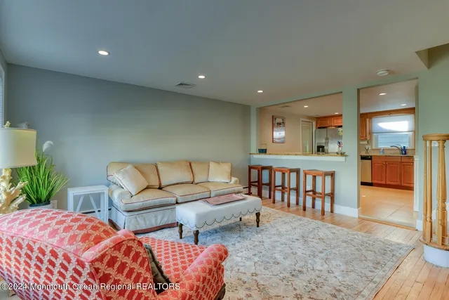 a spacious bedroom with a bed a couch and a potted plant