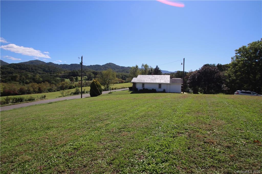 451 Possum Ridge Road Canton, NC 28716 - Photo 22 of 44 a view of a green field with mountain