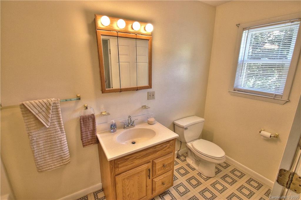 451 Possum Ridge Road Canton, NC 28716 - Photo 44 of 44 a bathroom with a sink toilet and window