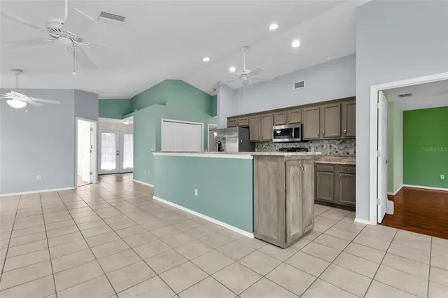 a kitchen with a sink a counter top space cabinets and stainless steel appliances