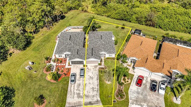 an aerial view of a house with a yard