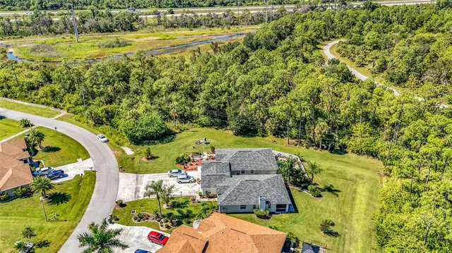 an aerial view of a house with a yard basket ball court and outdoor seating