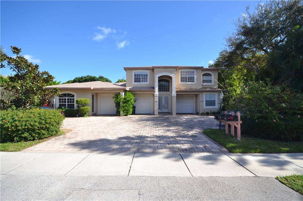 a front view of a house with a yard and a garage