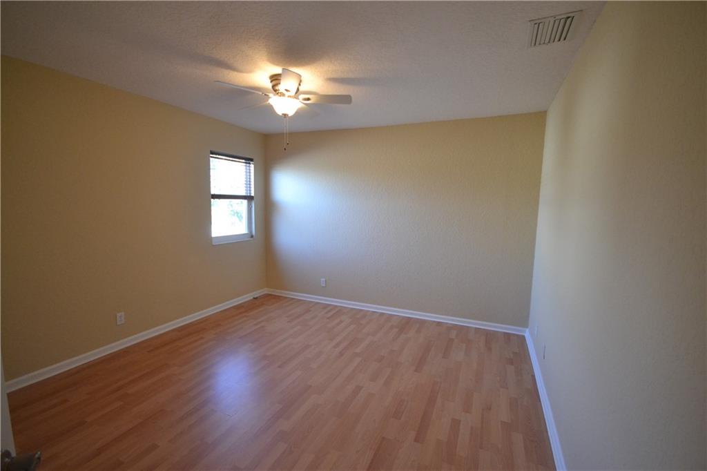 2809 Frederick Boulevard Delray Beach, FL 33483 - Photo 14 of 18 a view of empty room with window and wooden floor