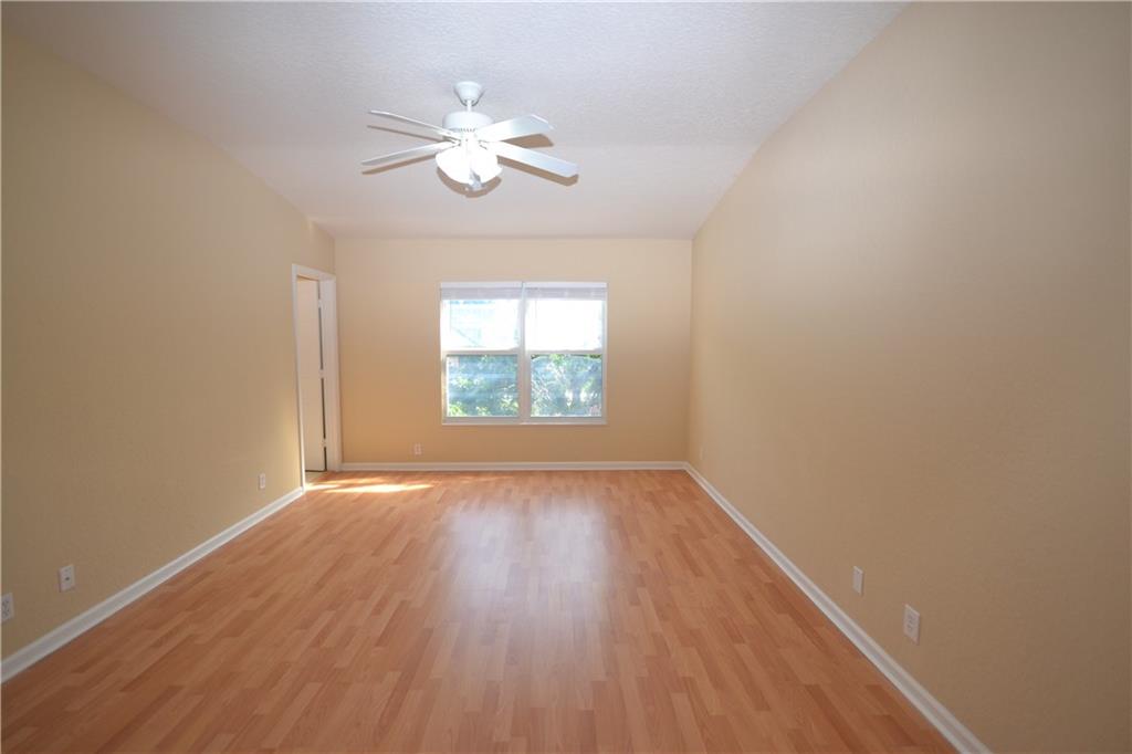 2809 Frederick Boulevard Delray Beach, FL 33483 - Photo 15 of 18 a view of an empty room with wooden floor and a window
